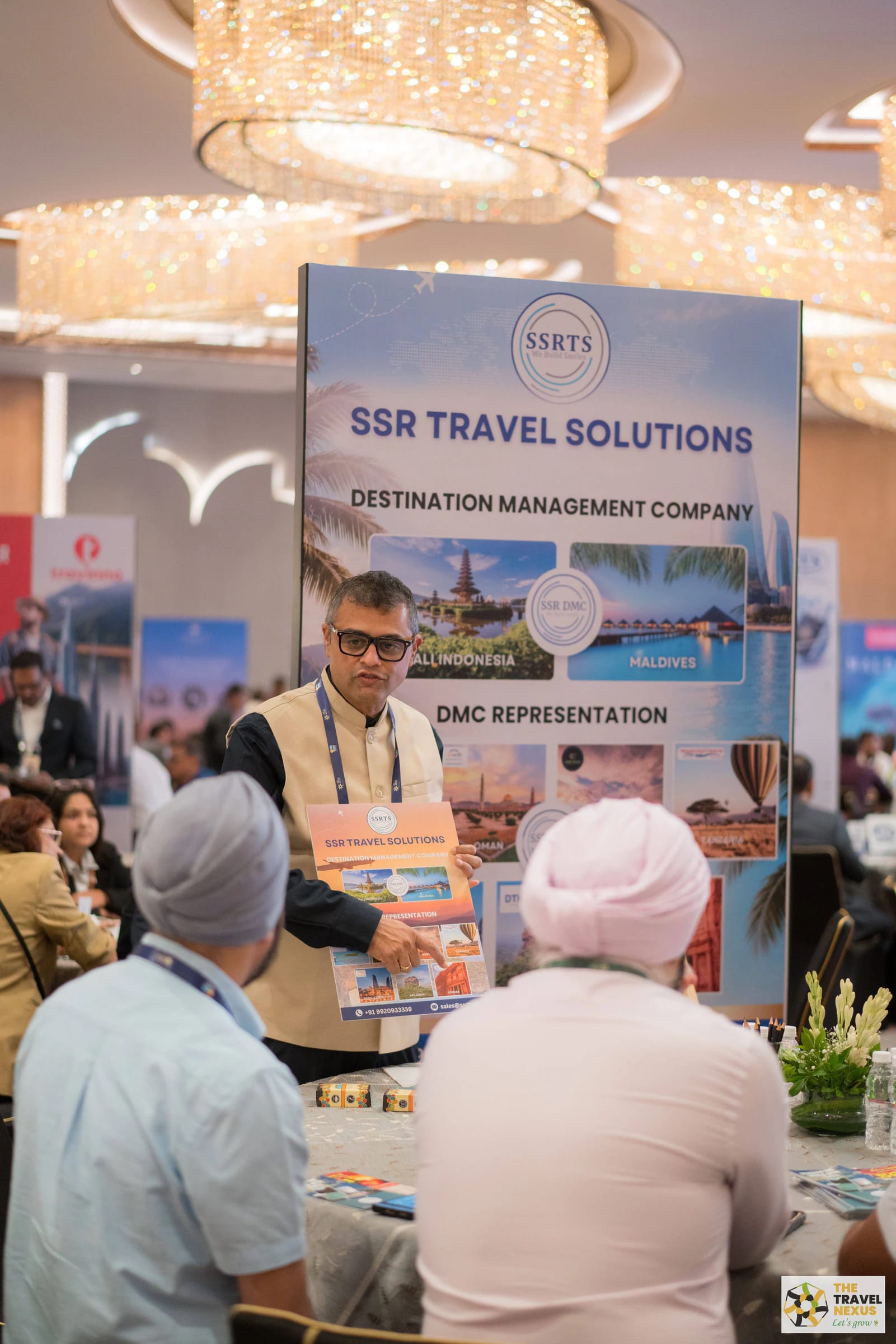 A destination representative presenting travel material to two seated delegates