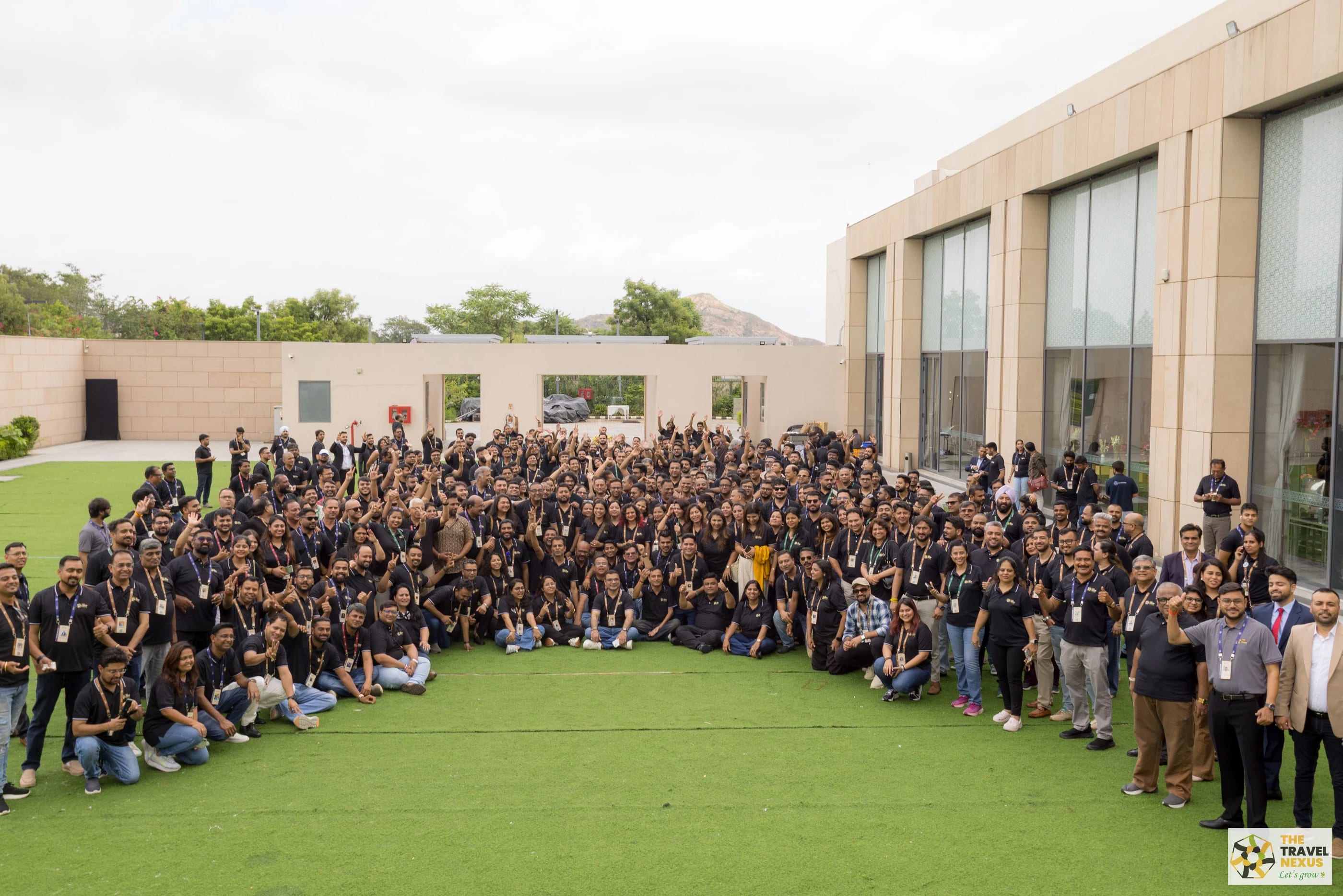 The full Travel Nexus community gathered outdoors for a wide group photograph