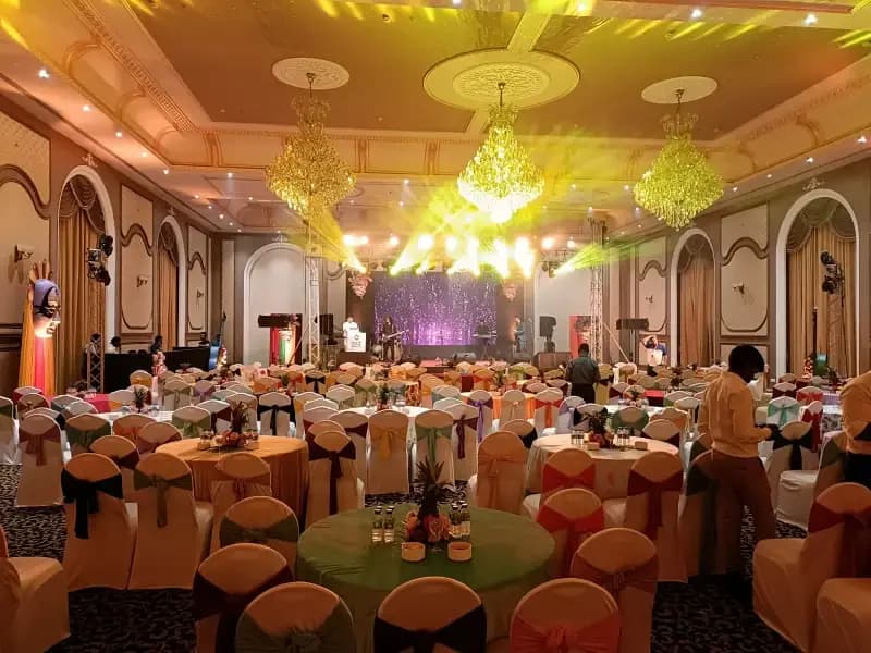 A banquet hall dressed for a Travel Nexus annual meet, tables laid under chandeliers before guests arrive