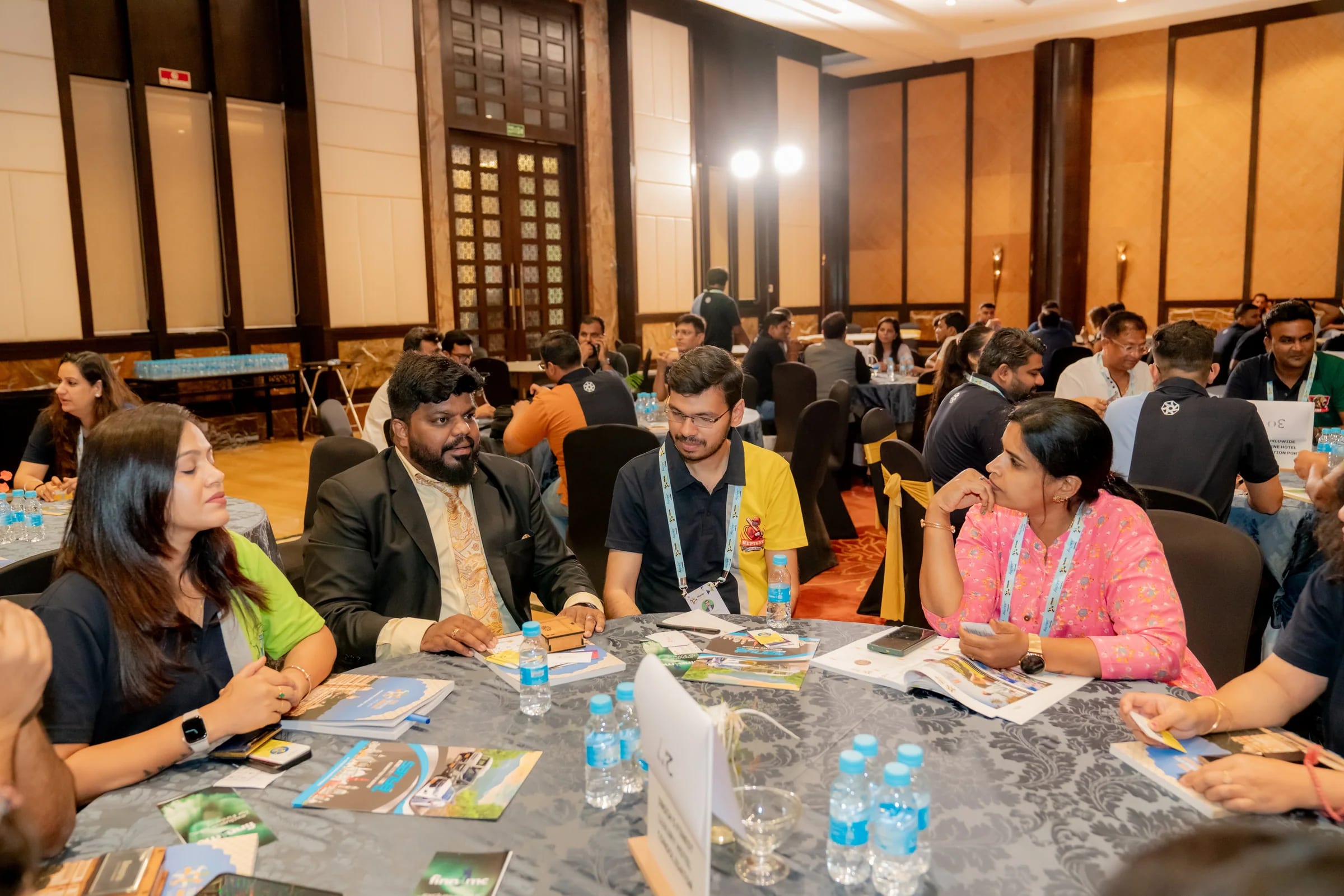 Travel professionals in conversation around a meeting table in Udaipur