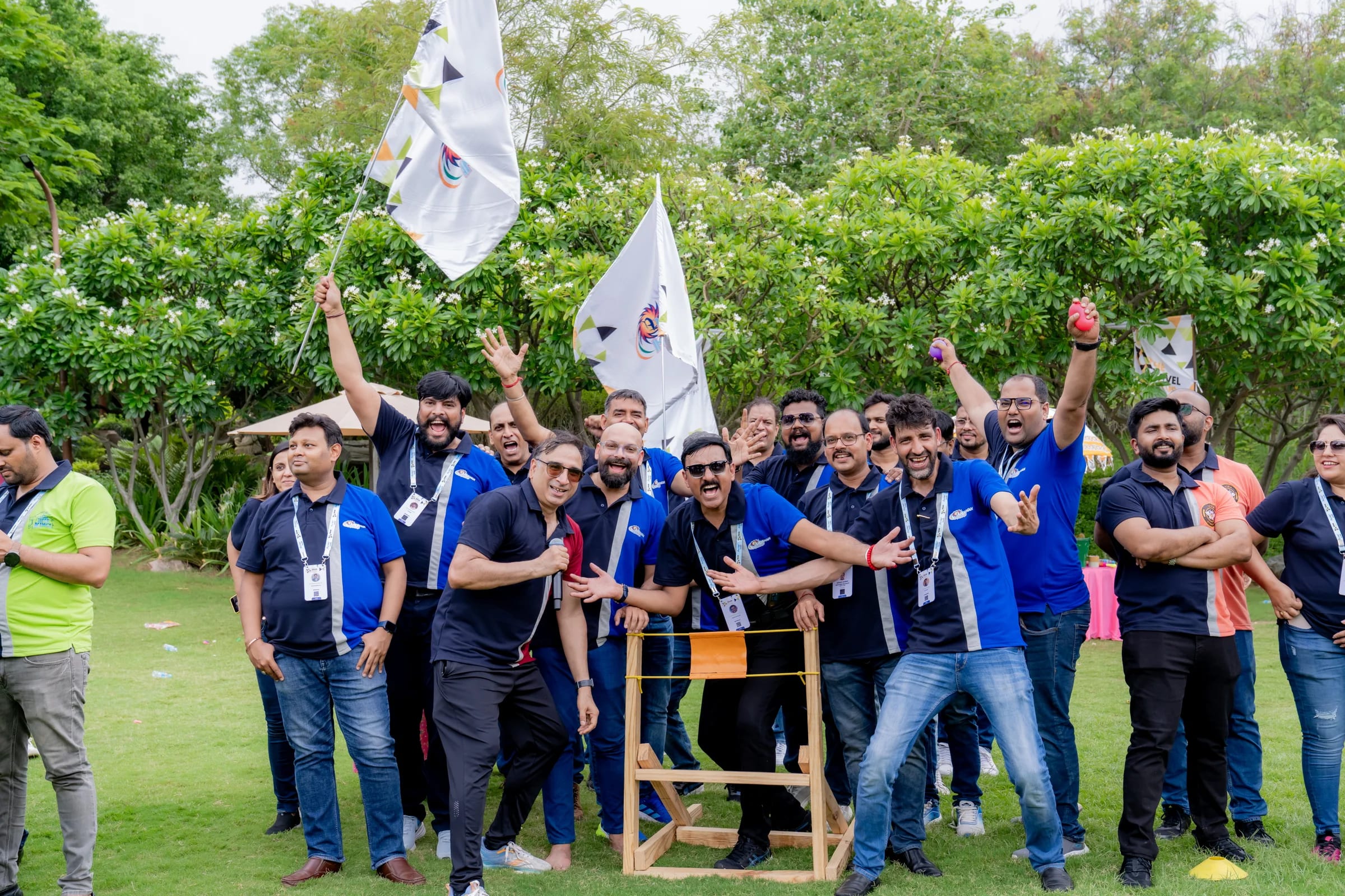 Travel Nexus teams gathering outdoors with flags at Ananta Udaipur