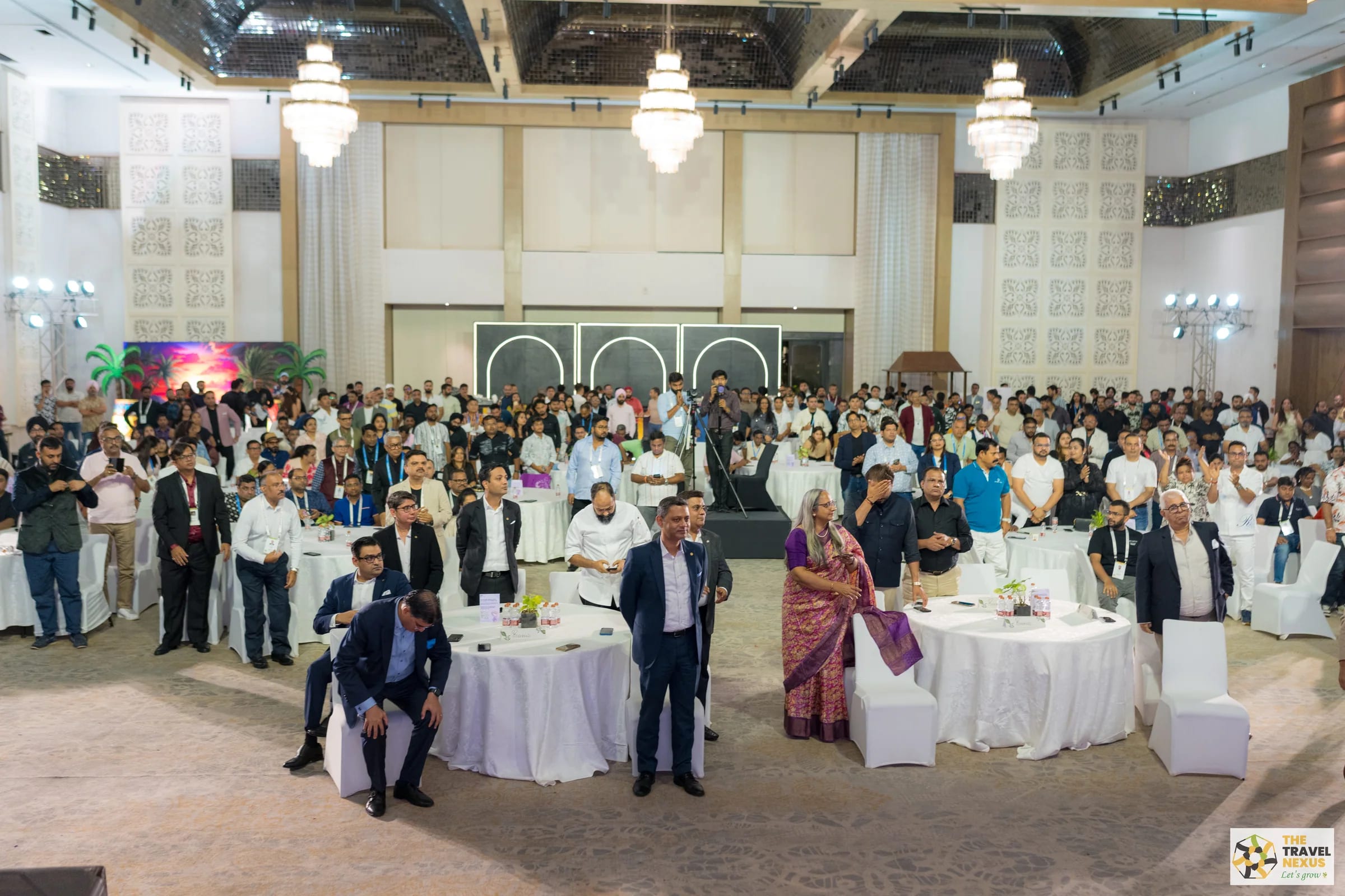 A wide view of delegates standing during the Goa programme
