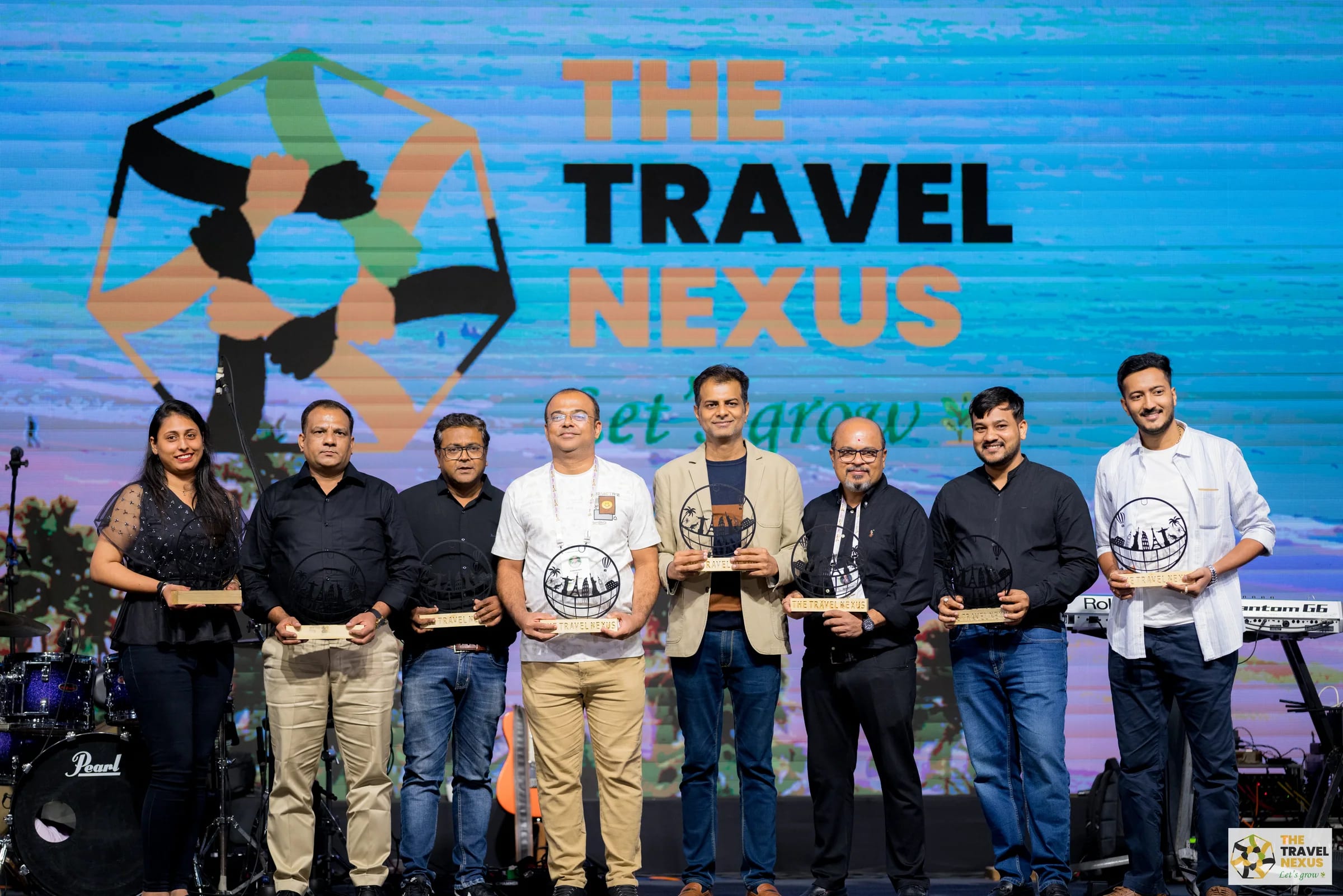 Members receiving recognition on the Travel Nexus 3.0 stage