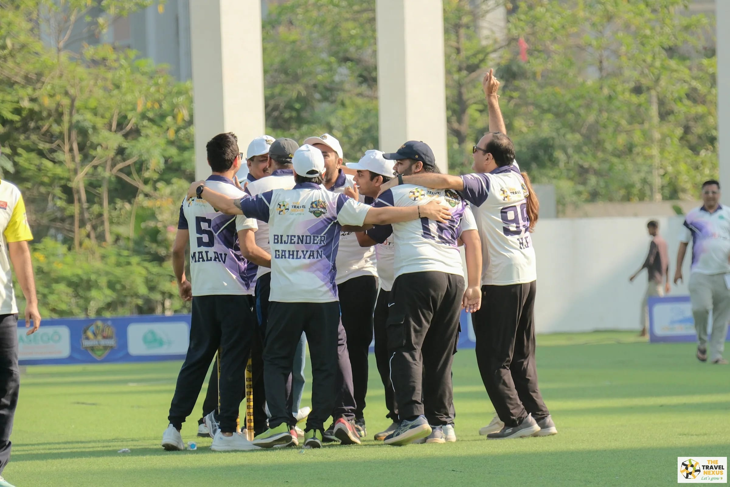Travel Nexus Cup players gathered in a team huddle